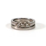 A platinum ring set three brilliant cut diamonds in an inline setting, together with a matching