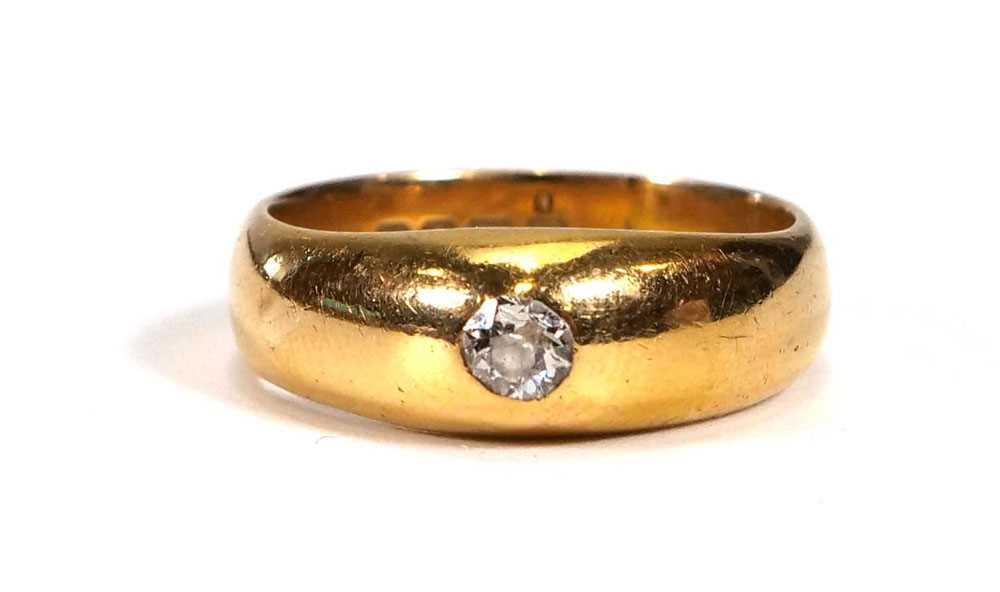 An early 20th century 18ct yellow gold ring set old cut diamond in a rubover setting, London 1917,