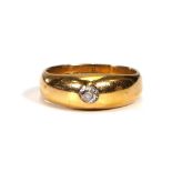 An early 20th century 18ct yellow gold ring set old cut diamond in a rubover setting, London 1917,
