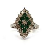 An 18ct white gold cluster ring set eight small emeralds and seventeen small diamonds in a diamond