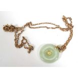 A 9ct yellow gold chainlink necklace suspending a green hardstone pendant, pendant d. 2.2 cm,