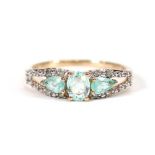 A 9ct yellow gold ring set three oval and pear cut paraiba tourmaline and small diamonds, total