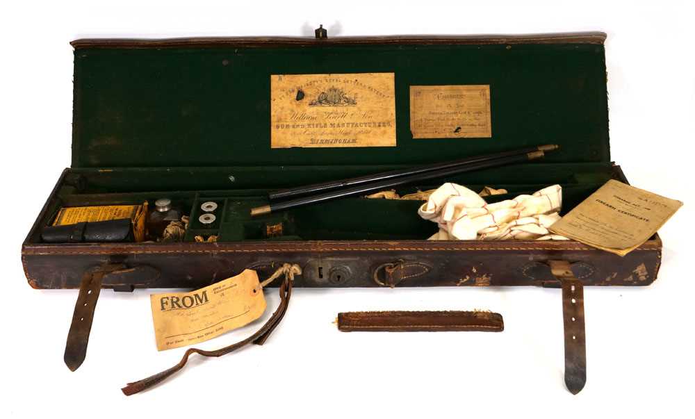 A William Powell & Son leather gun case, trade label to the interior, fitted with a pair of 12-