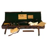 A William Powell & Son leather gun case, trade label to the interior, fitted with a pair of 12-