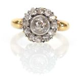 An early 20th century 18ct yellow gold cluster ring set old cut diamond within a border of twelve