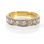 An 18ct yellow gold and white metal highlighted half eternity ring set seven graduated diamonds in