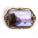 A 19th century enamelled brooch of rectangular form depicting a Continental lake scene within an