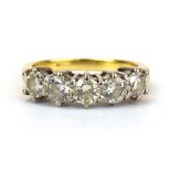 An 18ct yellow gold ring set five brilliant cut diamonds in an inline setting, total diamond