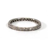 A white metal full eternity ring set small diamonds in scrolled engraved settings,ring size T,2.8