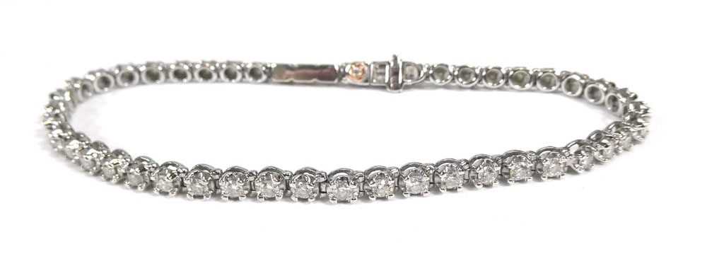 A 9ct white gold tennis bracelet set small diamonds, 10.3 gmsClasp currently stuck in place and