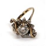 A 9ct yellow gold cluster ring set brilliant cut diamond within a double scroll setting, set