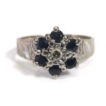 An 18ct white gold cluster ring set small diamond and sapphires within bark design shoulders,ring