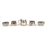 A silver mustard of squat form, h. 6.5 cm, two silver salts and two silver rimmed glass salts,