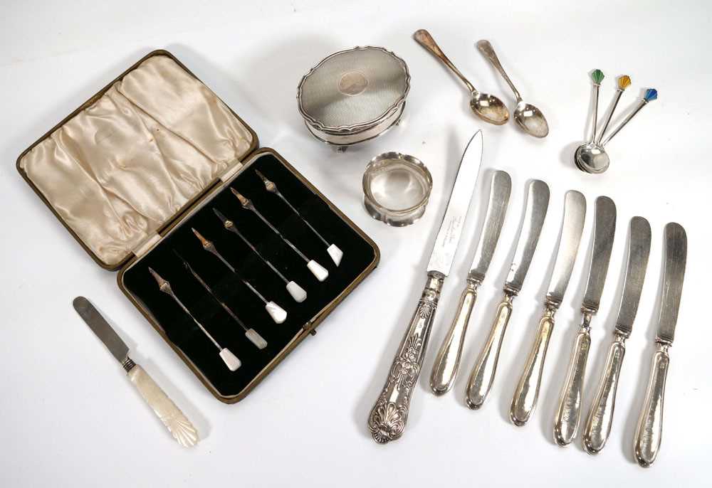 A group of silver comprising a cased set of six pickle forks, three enamelled teaspoons, two further