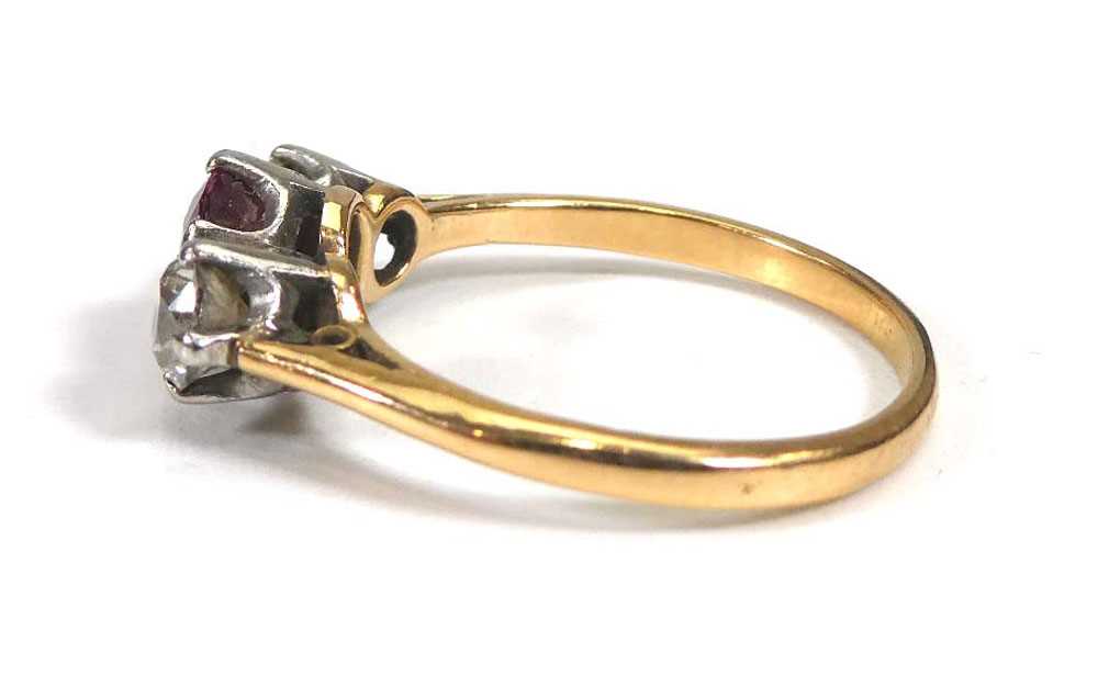 A yellow metal ring set round cut ruby and two old brilliant cut diamonds in an inline setting, - Image 2 of 4
