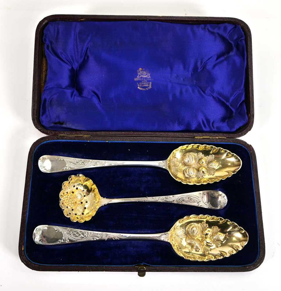 A pair of George III silver and parcel gilt berry spoons and a matching straining spoon, maker SH,