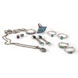 A silver pendant necklace and a pair of matching earrings, a ring set tanzanite and emerald, three