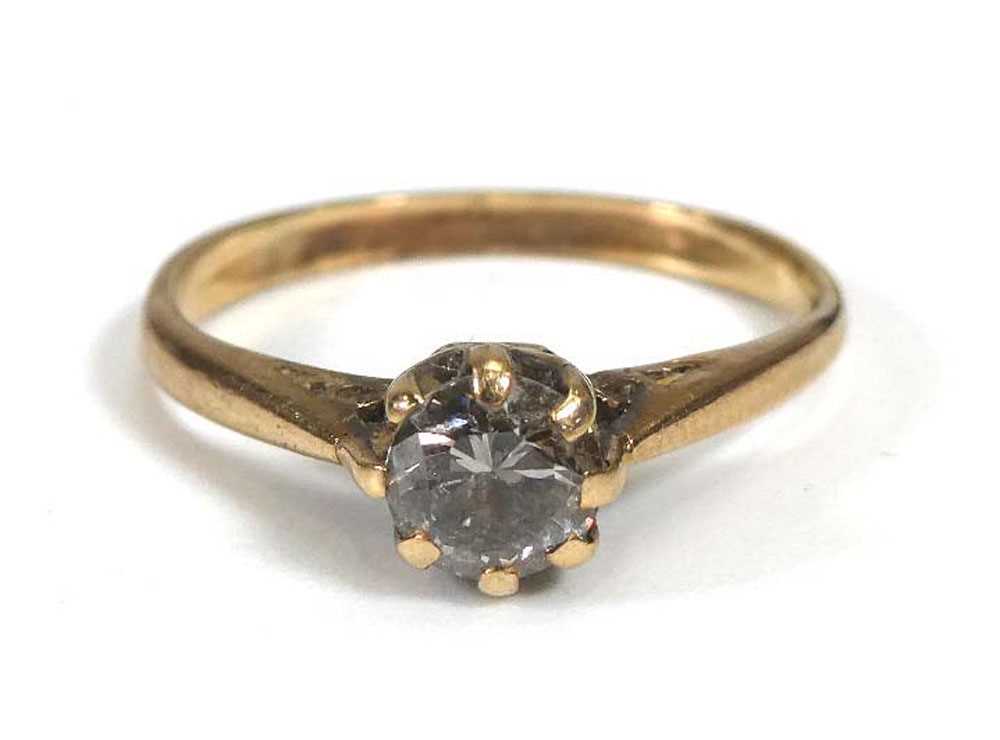 A yellow metal ring set small diamond in an eight claw setting,ring size M,1.6 gmsWell worn. Stone