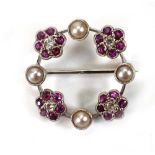 A white metal wreath brooch set diamond and ruby clusters and seed pearls, d. 1.9 cm, 3 gms