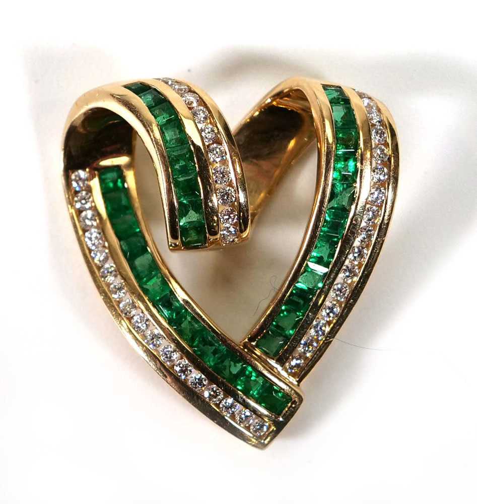 A 14ct yellow gold openwork pendant of heart shaped form set square cut emeralds and small