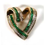 A 14ct yellow gold openwork pendant of heart shaped form set square cut emeralds and small