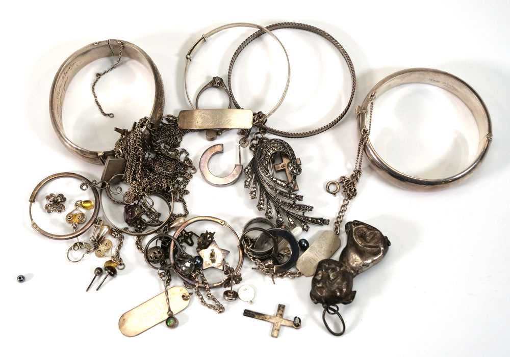 A group of silver and metalware jewellery including hinged bracelets, Christening bracelets, ear