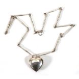 Astrid Fog for Georg Jensen, a silver elongated link necklace suspending a heart shaped pendant,