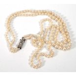A double strand graduated cultured pearl necklace with French gold and platinum highlighted clasp