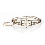 A silver gilt hinged bracelet set oval moonstone and seed pearls, internal w. 5.7 cm (af)Bent and