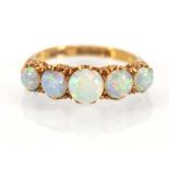 An early 20th century 18ct yellow gold rig set five graduated opals, maker IWR, London 1927,ring