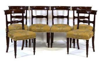 A set of six Victorian mahogany bar back dining chairs on reeded tapering legs