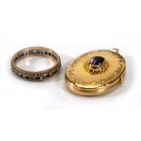 A 9ct yellow gold oval locket set amethyst, l. 3 cm and a 9ct gold eternity ring set blue and