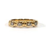 An 18ct yellow gold ring set four small diamonds in rubover setings,ring size I 1/2,3.1 gms