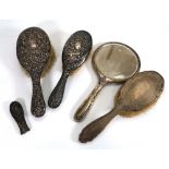 Three early 20th century silver mounted hairbrushes, a hand mirror and a handle part, various