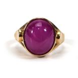 A 14ct yellow gold ring set cabochon (?)pink star sapphire in a rubover setting,ring size N,6 gms