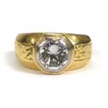 An 18ct yellow gold ring set brilliant cut diamond in an octagonal rubover setting within engraved