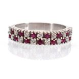 An 18ct white gold ring set two rows of fourteen small diamonds and rubies in a checkerboard