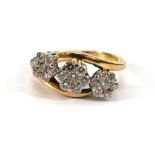 An 18ct yellow gold crossover ring set three diamond clusters,ring size N,5.2 gms