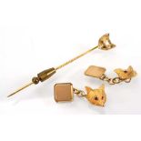 A pair of 9ct yellow gold cufflink's, each in the form of a fox's head, its eyes set small rubies,