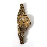 A ladies part 9ct yellow gold wristwatch by Vertex, the circular dial with Arabic numerals and