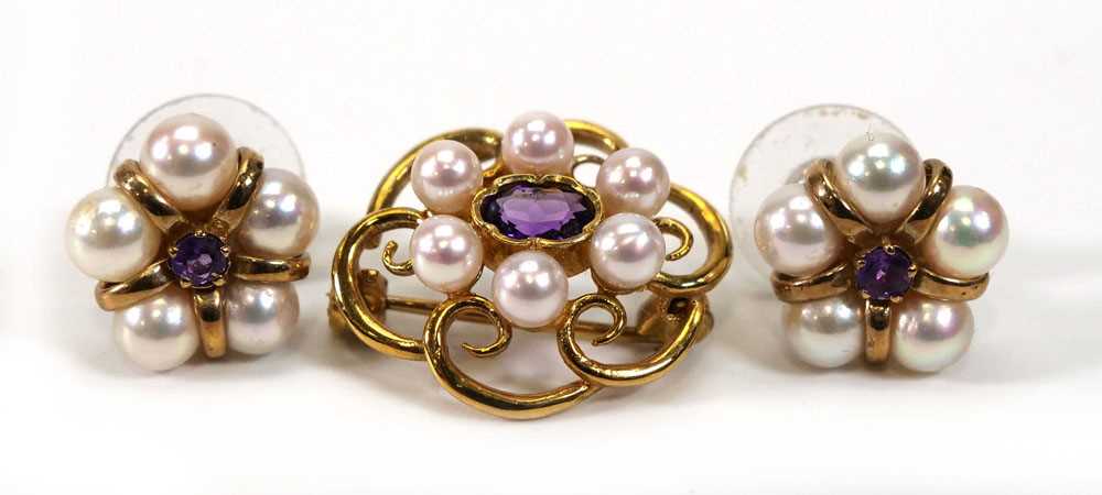 A 9ct yellow gold brooch set oval amethyst within a border of six cultured pearls, w. 2.2 cm,