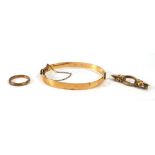A 9ct yellow gold bar brooch, a yellow metal ring and a part gold hinged bracelet (3)