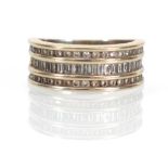 An 18ct yellow gold band ring set three rows of small brilliant and baguette cut diamonds,ring