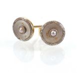 A pair of 9ct yellow gold studs, each set mother of pearl, d. 7 mm, overall 1.4 gms (2)Missing one