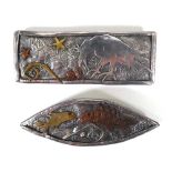 A hammered silver and gold overlaid brooch of rectangular form, relief decorated with a raven and