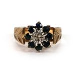 A 9ct yellow gold cluster ring set small diamond and eight small sapphires within engraved