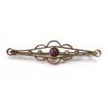 An early 20th century 9ct yellow gold openwork bar brooch set pink glass and seed pearls, w. 5.2 cm,