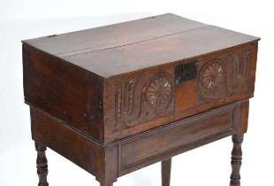 A 17th century and later oak Bible box-on-stand, the carved front converted to a drawer, on turned