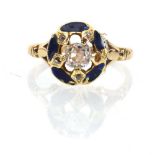 An early 20th century 18ct yellow gold ring set old cut diamonds within a blue enamelled mount set