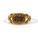 A George IV 18ct yellow gold mourning ring set plaited hair in a scrolled setting, London 1829,